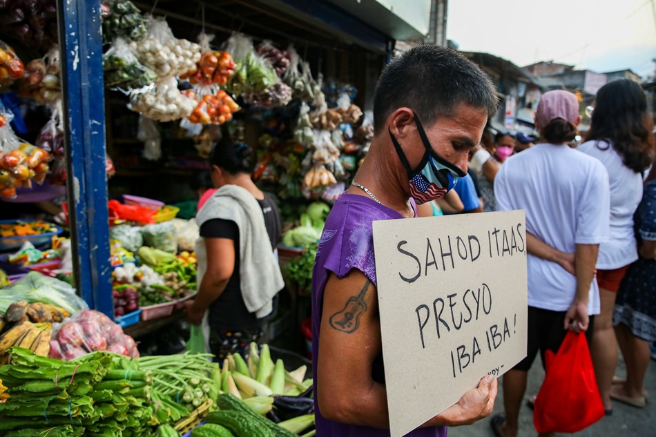 Members of urban poor group Kalipunan ng Damayang Mahihirap (Kadamay) hold a price hike protest at the San Roque Public Market in Quezon City on March 4, 2022. Jonathan Cellona, ABS-CBN News/file