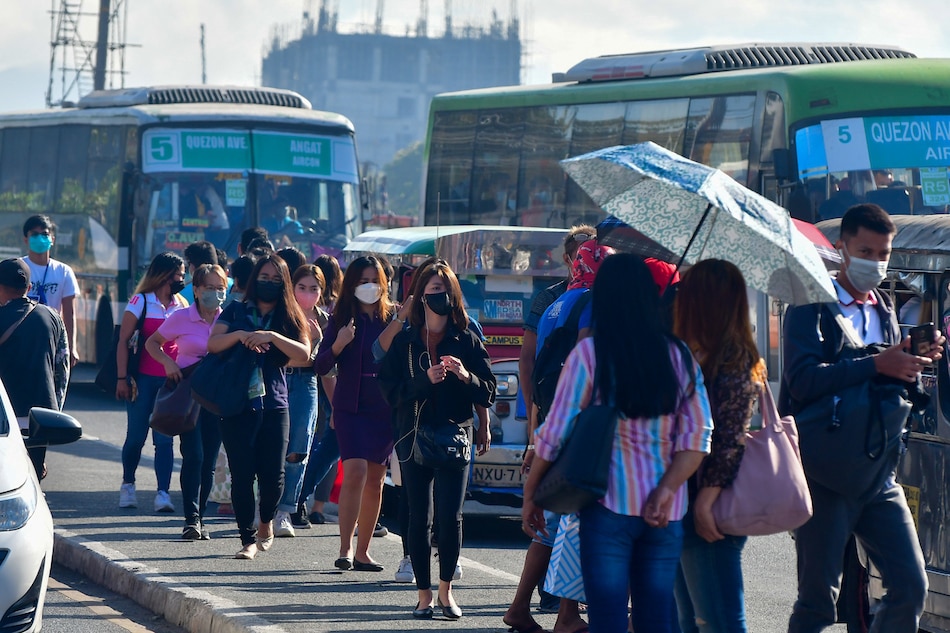 Commuters wait for a ride along Commonwealth Avenue in Quezon City on March 3, 2022, as Metro Manila is placed under Alert Level 1, the least strict quarantine level. Mark Demayo, ABS-CBN News