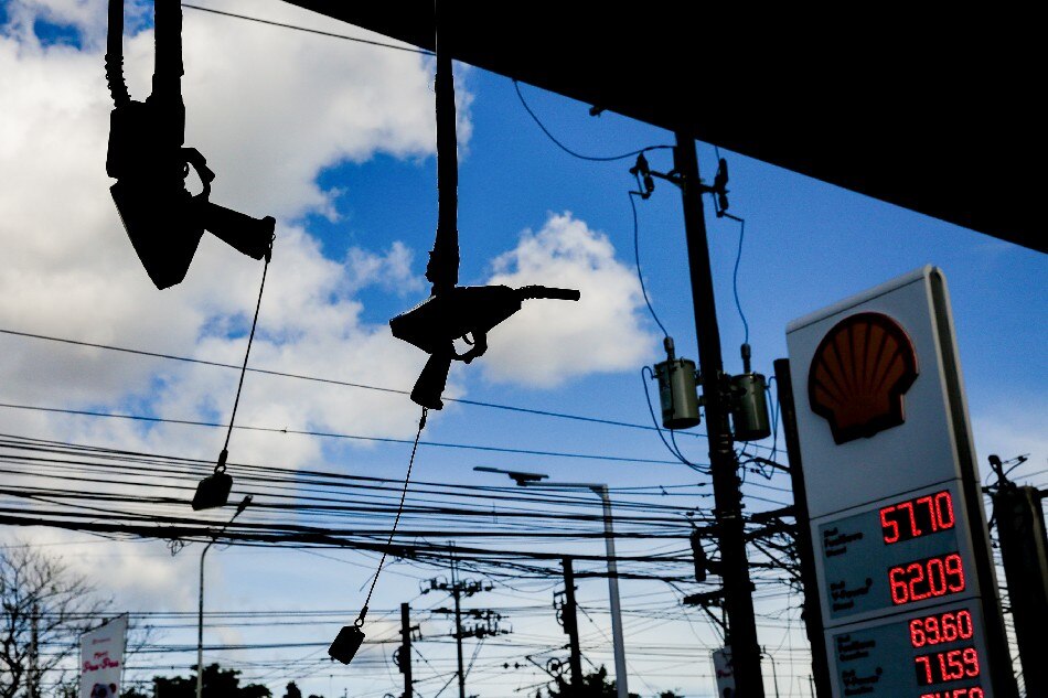 Fuel nozzles hang at a gasoline station in Manila on Feb. 26, 2022. Gasoline prices which already increased for 8 straight weeks recently are expected to rise further amid the escalating conflict between Ukraine and Russia. George Calvelo, ABS-CBN News/File