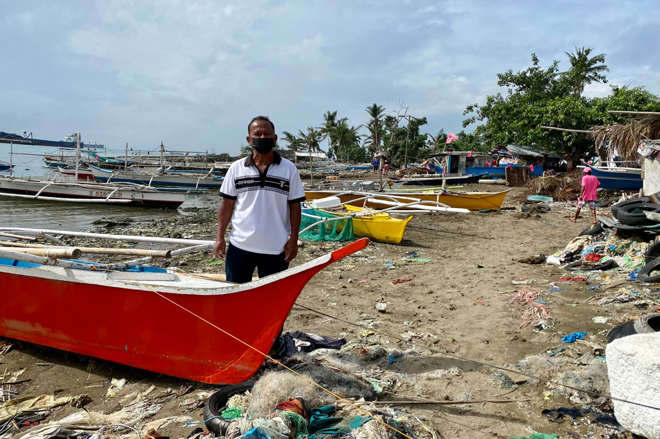Fisherman Rene Mabanto stands beside a boat in Barangay Tangke, Talisay Cebu, as the community waits for the arrival of Vice President Leni Robredo. ABS-CBN News 
