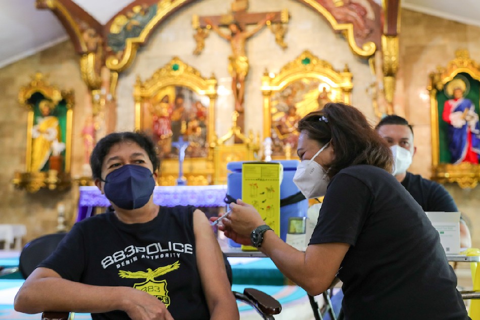  Residents receive their COVID-19 vaccine at the Saint Peter and John Parish in Malabon City on March 10, 2022 as the Department of Health held its National Vaccination Days Part 4 in an attempt to reach places with low vaccination turn out. Jonathan Cellona, ABS-CBN News