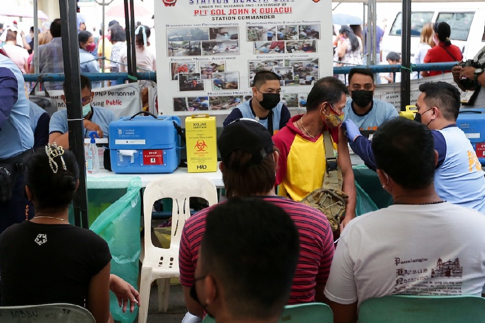 People receive their COVID-19 shots at a vaccination site at the Plaza Miranda in Quiapo, Manila on March 11, 2022. George Calvelo, ABS-CBN News