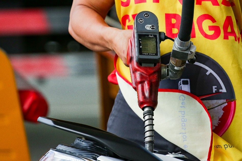 A motorcycle rider stops for a refill at a gasoline station in Manila on February 26, 2022. Gasoline prices which already increased for 8 straight weeks recently are expected to rise further amid the escalating conflict between Ukraine and Russia. George Calvelo, ABS-CBN News