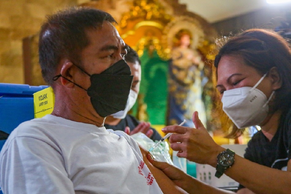 Residents receive their COVID-19 vaccine at the Saint Peter and John Parish in Malabon City on March 10, 2022 as the Department of Health resumed its National Vaccination Days Part 4 in an attempt to reach places with low vaccination turn out. Jonathan Cellona, ABS-CBN News