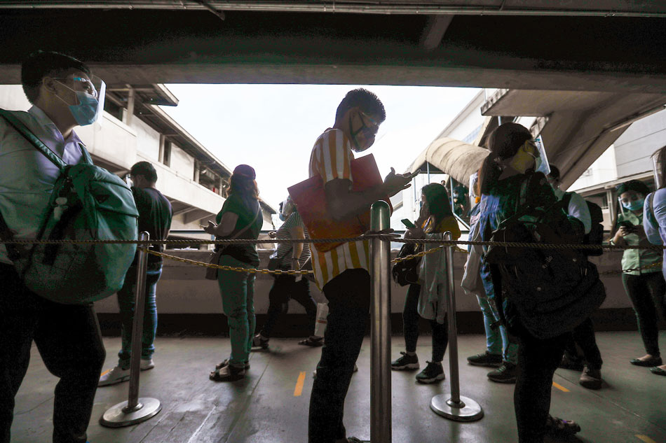  Passengers try the contact tracing app launched by MRT-3 at the North Avenue Station in Quezon City on January 18, 2021. Jonathan Cellona, ABS-CBN News/File 