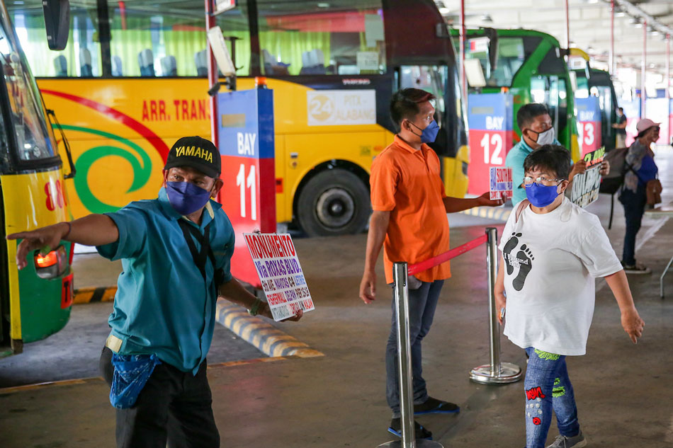  Bus drivers and conductors call out passengers at the Paranaque Integrated Terminal Exchange (PITX) in Parañaque City on March 3, 2022. Public utility vehicles are now allowed to accommodate up to their full capacity under alert level 1. George Calvelo, ABS-CBN News
