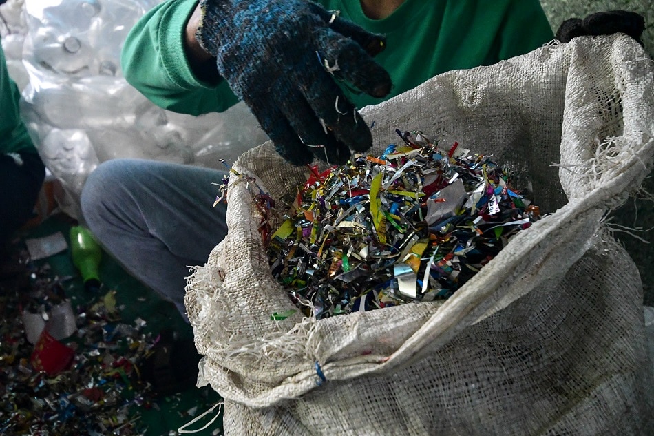 Workers sort and check cut-up sachet plastics before further shredding at one of Green Antz' sites in Plaridel, Bulacan. Mark Demayo, ABS-CBN News