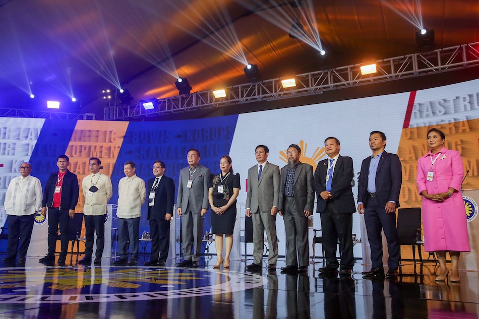 Presidential candidates pose for a group photo moments before the start of COMELEC’s official debates held at the Sofitel Tent in Pasay City on March 19, 2022. George Calvelo, ABS-CBN News