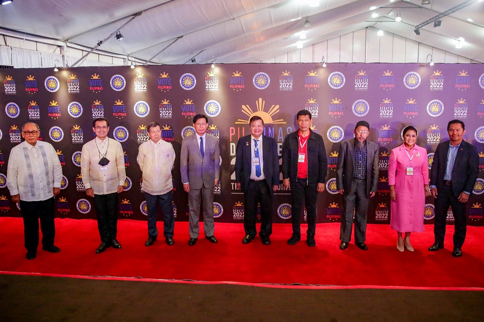 Presidential candidates pose for a group photo moments before the start of COMELEC’s official debates held at the Sofitel Tent in Pasay City on March 19, 2022. George Calvelo, ABS-CBN News.