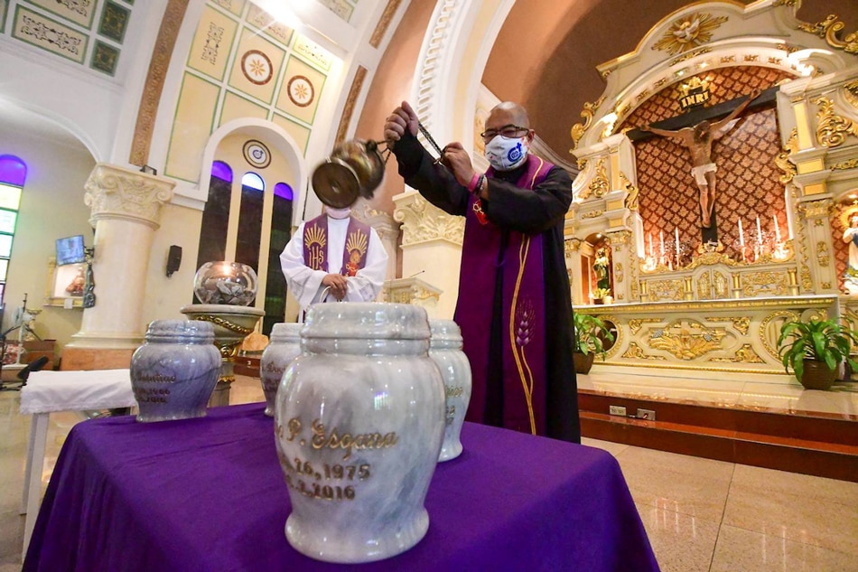 Relatives of drug war victims receive the cremated remains of their loved ones during a church ceremony in Quezon City on March 28, 2022, as part of Project Arise. Most of the victim's leased gravesites neared its expiry and the cremation was given for free. The project is in line with the Arnold Janssen Kalinga Foundation's Program Paghilom in assisting families of extrajudicial killing victims in healing and rebuilding their lives. Mark Demayo, ABS-CBN News