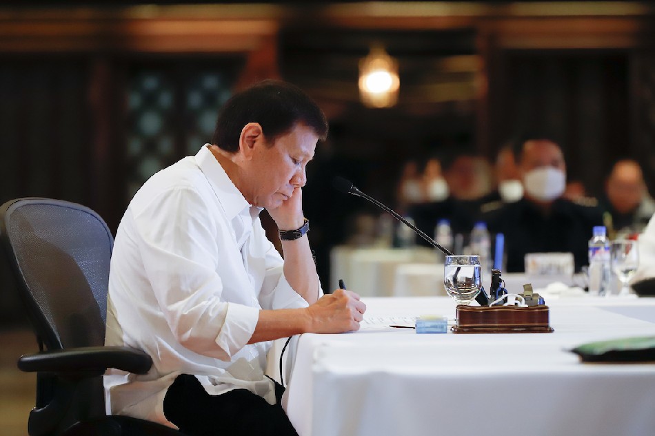 President Rodrigo Roa Duterte skims through a document while presiding over the joint Armed Forces of the Philippines-Philippine National Police command conference at the Malacañan Palace on April 6, 2022. Rey Baniquet, Presidential Photo