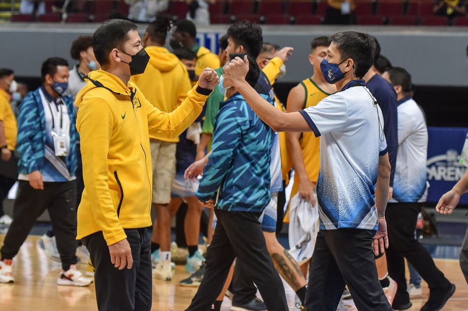 Adamson coach Nash Racela exchange fist bumps with his older brother and FEU head coach Olsen Racela after their UAAP Season 84 second round game. UAAP Media.