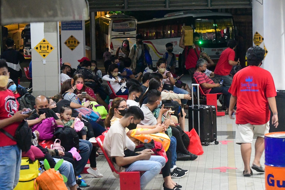 Passengers wait for their bus ride at a terminal in Quezon City on April 12, 2022. A number of passengers travel ahead of the influx during the Lenten holidays after two years in lockdown and COVID-19 alert levels going down across the country. Mark Demayo, ABS-CBN News