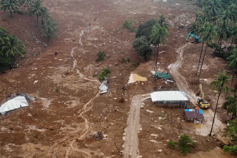 This aerial photo shows the collapsed mountain side and buried houses in the village of Bunga, Baybay town, Leyte province, in southern Philippines on April 12, 2022, a day after a landslide slammed into the village due to heavy rains brought about by tropical storm Megi. Bobbie Alota, AFP
