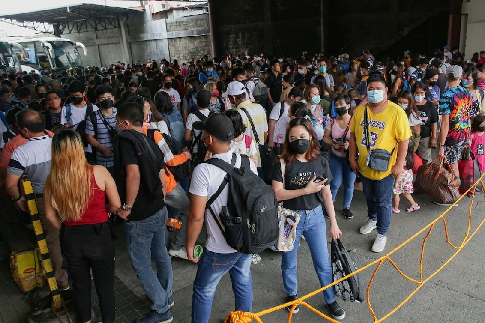 Passengers flock to a bus station along EDSA in Cubao, Quezon City on April 13, 2022. Thousands of Filipinos are expected to go home to their respective provinces for the long holiday break as the country observes the Holy Week. George Calvelo, ABS-CBN News