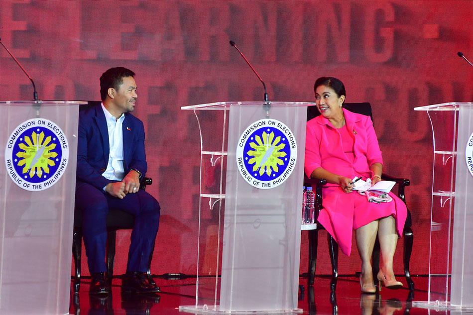 Presidential candidate Senator Manny Pacquiao interacts with Vice President Leni Robredo during the second Commission on Elections’ #PilipinasDebates2022: The Turning Point at the Sofitel Tent in Pasay City on April 3, 2022. Mark Demayo, ABS-CBN News/File 