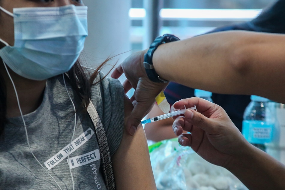 A woman gets her COVID-19 vaccine on April 19, 2022. Jonathan Cellona, ABS-CBN News