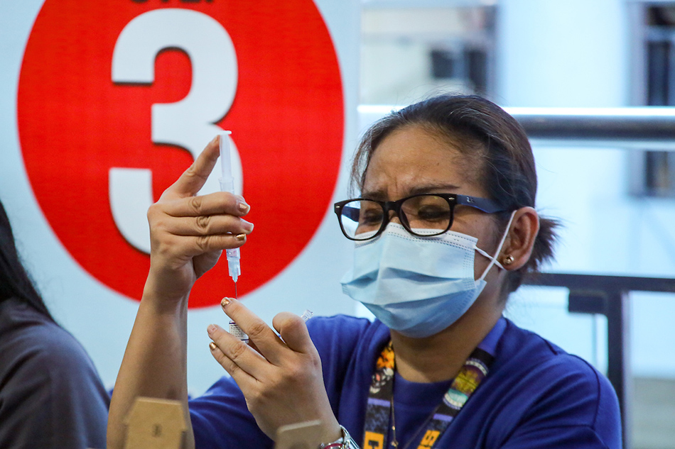 Residents get their COVID-19 vaccination at the Mandaluyong City Hall on April 19, 2022. The Mandaluyong City Health Department continues with its vaccination as well as booster jabs to all its citizens. Jonathan Cellona, ABS-CBN News/file