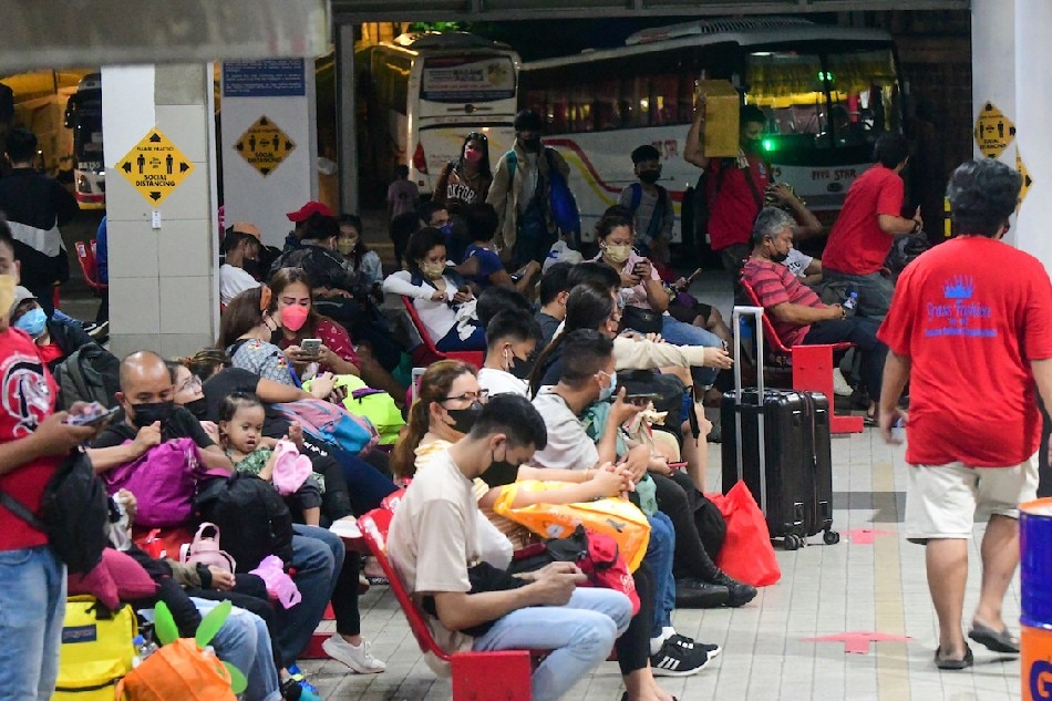 Passengers wait for their bus ride at a terminal in Quezon City on April 12, 2022. A number of passengers travel ahead of the influx during the Lenten holidays after two years in lockdown and COVID-19 alert levels going down across the country. Mark Demayo, ABS-CBN News