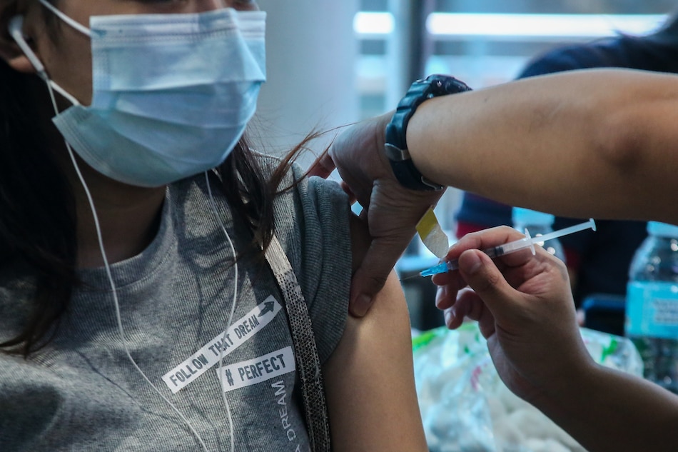 A woman gets her COVID-19 vaccination at the Mandaluyong City Hall on April 19, 2022. Jonathan Cellona, ABS-CBN News