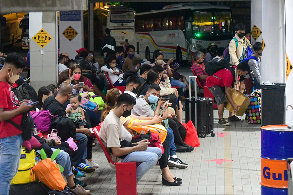 Passengers wait for their bus ride heading to the provinces at a terminal in Quezon City on April 12, 2022. Mark Demayo, ABS-CBN News/file