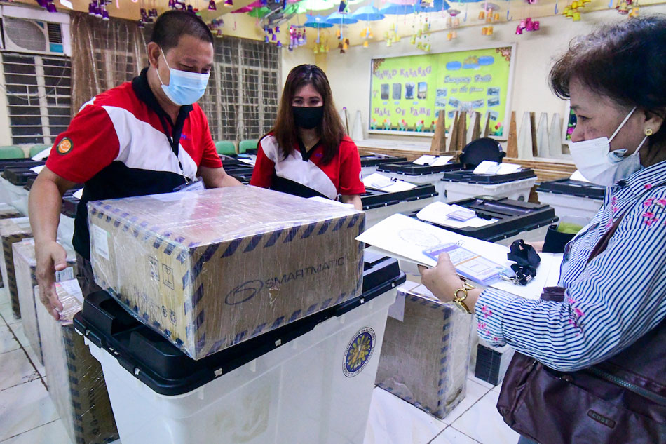 Members of the Electoral Board and poll watchers conduct their final testing and sealing of vote counting machines at Melencio M. Castelo Elementary School in Quezon City on May 3, 2022. Around 65.7 million domestic voters are expected to cast their votes for national and local positions for the May 9 election. Mark Demayo, ABS-CBN News