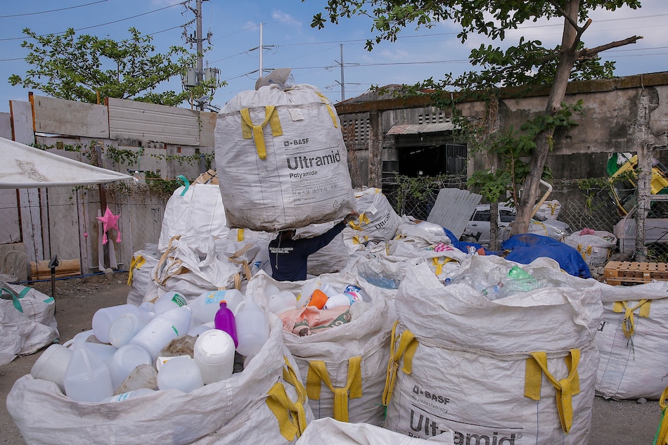 Workers prepare to resume their work at The Plastic Flamingo recycling facility in Muntinlupa City on March 18, 2022. George Calvelo, ABS-CBN News