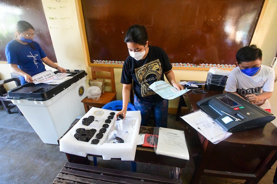 Members of the Electoral Board and poll watchers conduct their final testing and sealing of vote counting machines at Melencio M. Castelo Elementary School in Quezon City on May 3, 2022, ahead of the national and local elections on May 9. Mark Demayo, ABS-CBN News