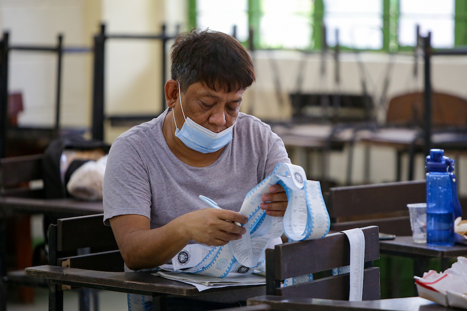 Teachers who will be serving as poll workers inspect election equipment for validation during its final testing and sealing (FTS) at the Tondo Highschool in Manila on May 4, 2022. George Calvelo, ABS-CBN News