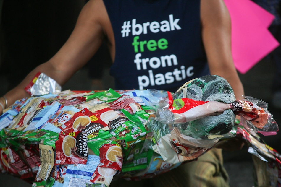 Environmental activists of Greenpeace hold plackards and letters as they hold a ’Break Free From Plastics’ protest in front of the building where Nestle’ Philippines is located, in Makati City on March 23, 2022. Jonathan Cellona, ABS-CBN News