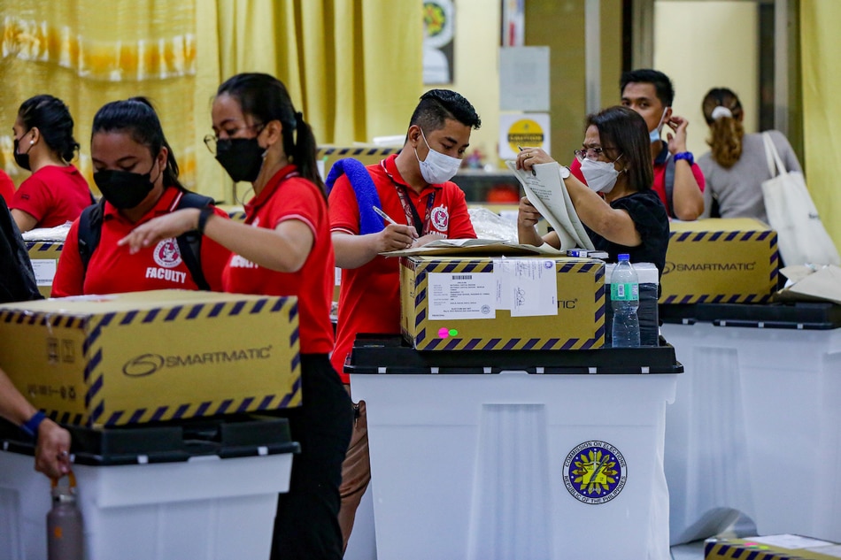  Poll workers inspect election equipment for validation during its final testing and sealing (FTS) at the Tondo Highschool in Manila on May 4, 2022. George Calvelo, ABS-CBN News