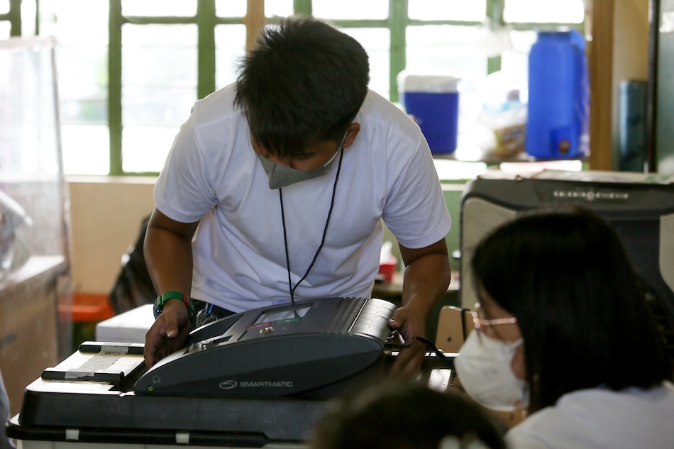 An electoral board member check a vote counting machine at the Herminigildo Atienza Elementary School in Baseco, Tondo, Manila during the national elections on May 9, 2022. Fernando G. Sepe Jr., ABS-CBN News