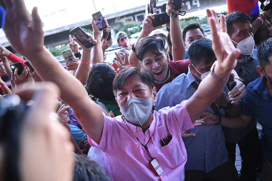 Presidential candidate Ferdinand Marcos Jr greets supporters as he arrives at the campaign heaquarters in Manila on May 11, 2022. The son of the late Philippines dictator Ferdinand Marcos on May 11 claimed victory in the presidential election, vowing to be a leader 'for all Filipinos', his spokesman said. Ted Aljibe, AFP