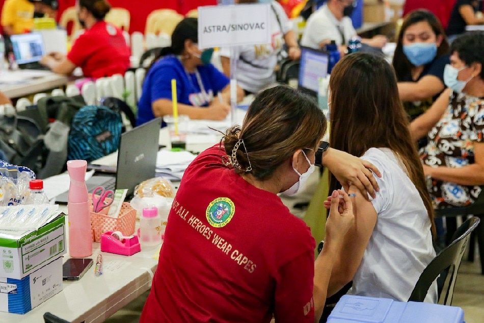 People get their second COVID-19 booster shot at a vaccination site inside Robinson’s Place Manila on April 26, 2022. George Calvelo, ABS-CBN News