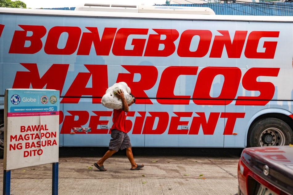 A man walks past an election campaign bus   ABS-CBN News