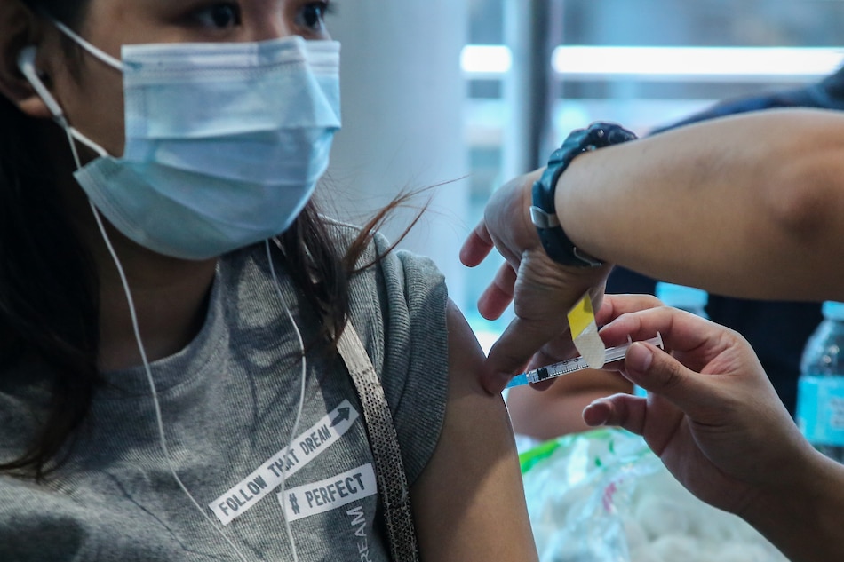 A woman gets her Covid-19 vaccination at the Mandaluyong City Hall on April 19, 2022. Jonathan Cellona, ABS-CBN News
