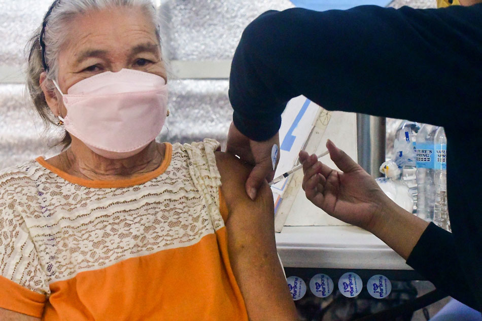 An elderly Marikina City resident receives her second COVID-19 vaccine booster shot on May 19, 2022. Mark Demayo, ABS-CBN News
