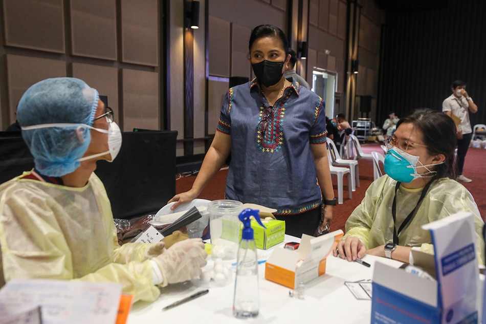  Vice President Leni Robredo looks on as health workers inoculate San Fernando, Pampanga residents under the A4 category against COVID-19 during the Office of the Vice President’s Vaccine Express initiative at the Laus Convention Center on Sept. 17, 2021. Jay Ganzon, OVP/File