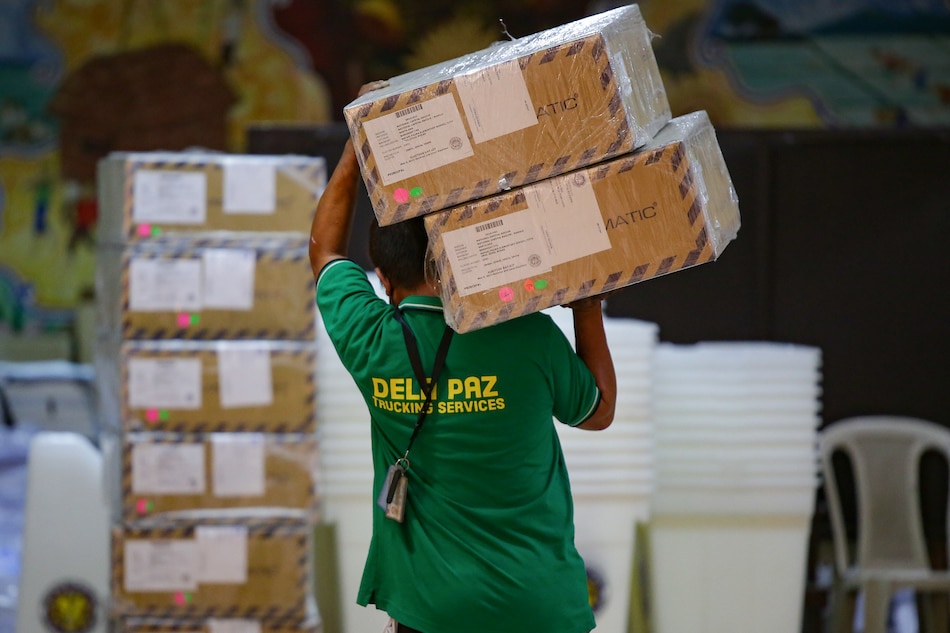 Workers unload election equipment at the Rafael Palma Elementary School in Manila on May 3, 2022. George Calvelo, ABS-CBN News