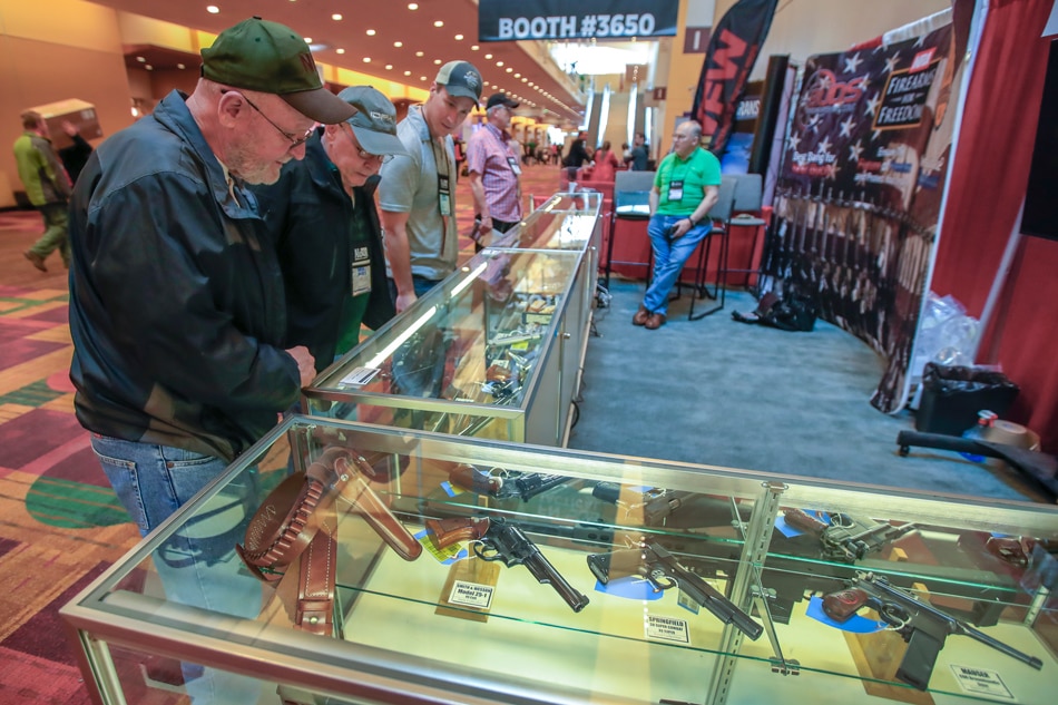 People looks at firearms on display at the 2019 National Rifle Association (NRA) Annual Convention at the Indianapolis Convention Center in Indianapolis, Indiana, USA, April 25, 2019. Firearms and weapons enthusiasts will view manufacture's exhibits on all things related to firearms, protection, and hunting. Tannen Maury, EPA-EFE