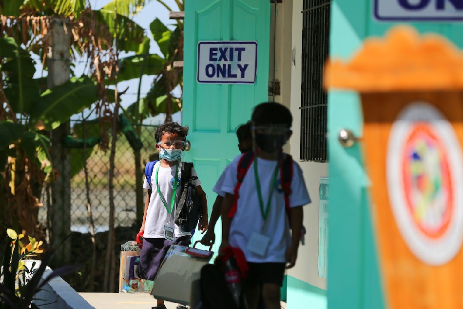 Pupils observe minimum health protocols as they attend the first day of limited face-to-face classes at the Longos Elementary School in Barangay Pangapisan in Alaminos City, Pangasinan on November 15, 2021. Jonathan Cellona, ABS-CBN News/File