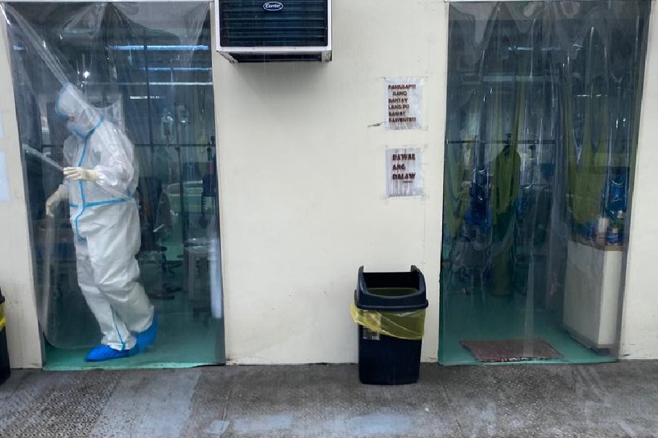 A medical worker wearing a protective suit walks from an isolation room outside of a hospital in Paranaque, Metro Manila on August 24, 2021. Francis R. Malasig, EPA-EFE/file