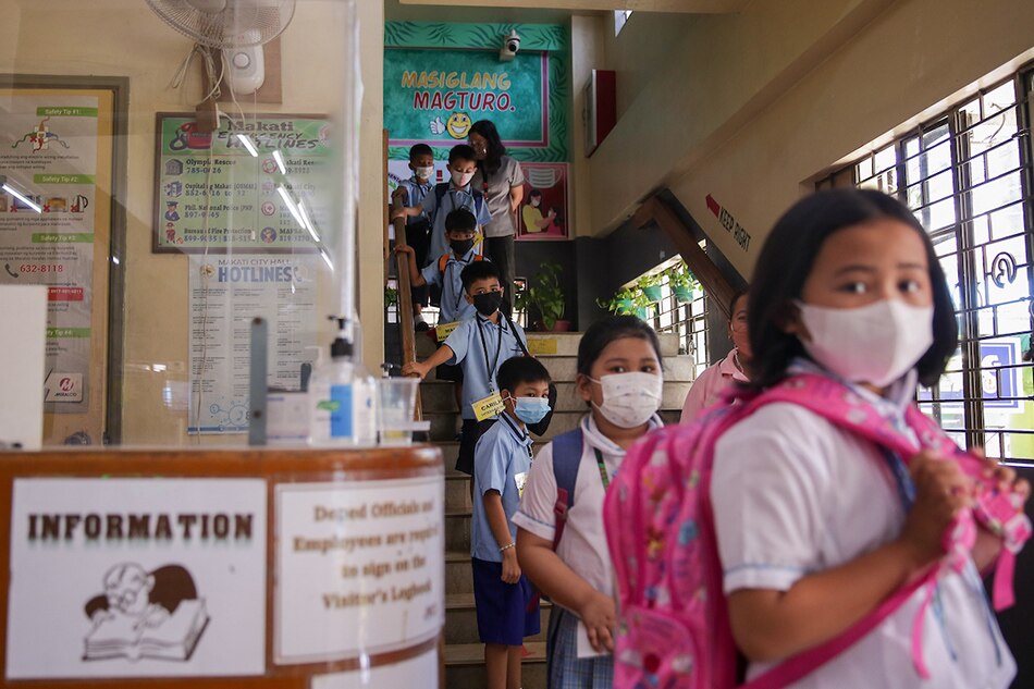 Students exit from the Jose Magsaysay Elementary School (JMES) in Makati City on March 30, 2022. George Calvelo, ABS-CBN News