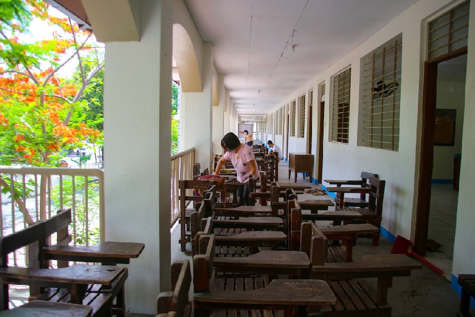 Teachers clean classrooms at the Marikina Heights National High School in Marikina City on May 2, 2022 for Comelec’s final testing of the Vote Counting Machines (VCMs) in preparation for the May 9 national elections. Jonathan Cellona, ABS-CBN News/File