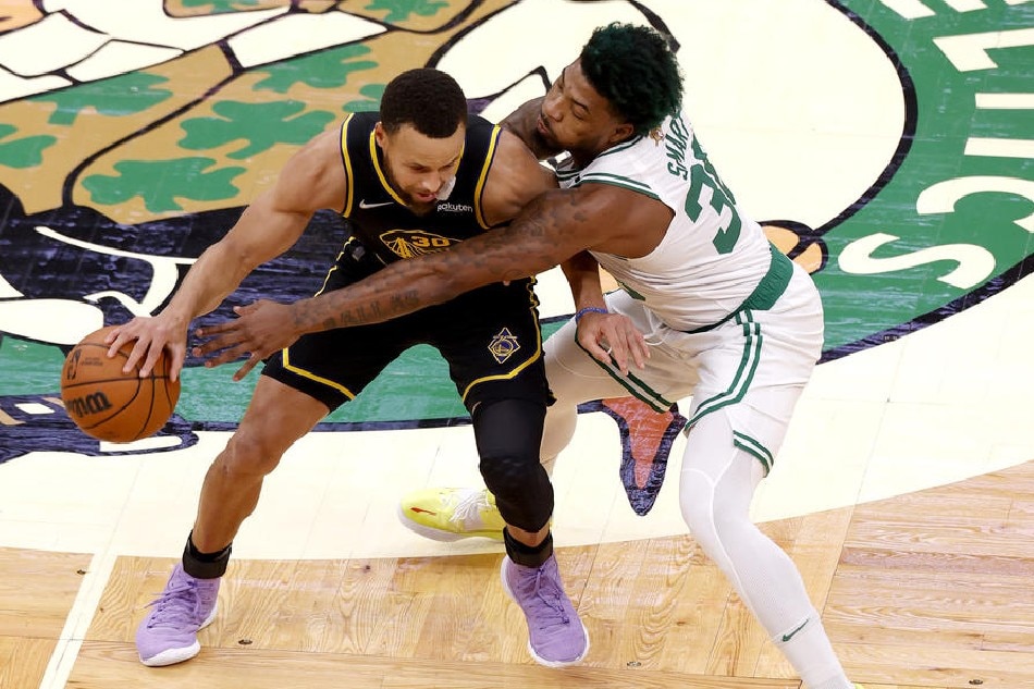 Warriors guard Steph Curry and Celtics guard Marcus Smart in action in Game 4 of the NBA Finals on June 10, 2022. CJ Gunther, Shutterstock Out/EPA-EFE