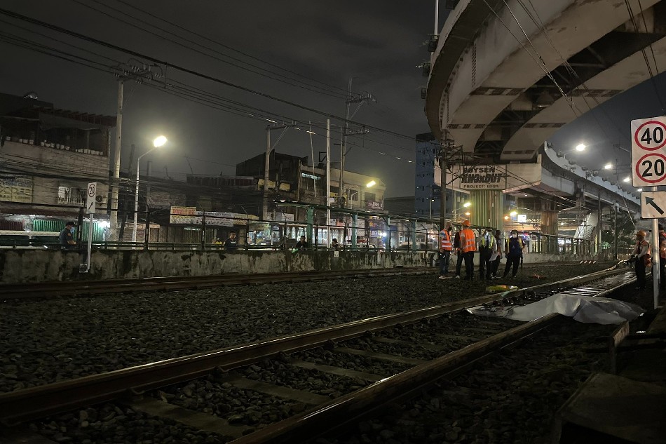 A tarp covers the 2 bodies lying on the tracks of the MRT-3. Two persons reportedly fell from the flyover and onto the tracks. Police are investigating the incident. Anna Cerezo, ABS-CBN News