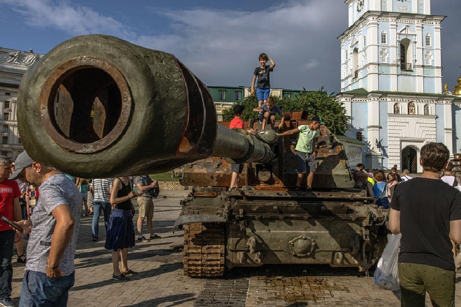 Boys climb on a Russian tank which was destroyed in fights with the Ukrainian army, displayed at Mykhailivskyi Square, in Kyiv, Ukraine, June 12, 2022. On Feb. 24, Russian troops entered Ukrainian territory starting a conflict that has provoked destruction and a humanitarian crisis. Roman Pilipey, EPA-EFE