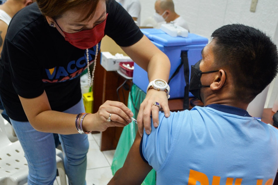 Manila cops line up to get their COVID-19 vaccine second booster shot at the Rizal Hall of the Manila Police District (MPD) Headquarters on Tuesday. Mores Heramis, ABS-CBN News