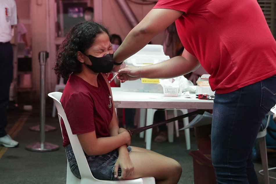  Health workers administer booster shots to minors at the Cardinal Santos Medical Center vaccination site in San Juan City on June 23, 2022. George Calvelo, ABS-CBN News