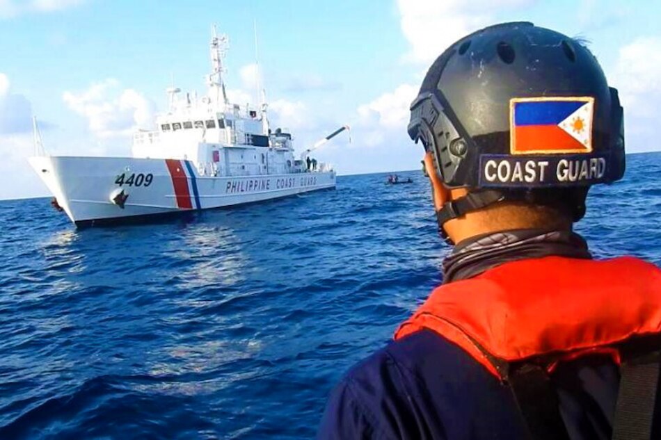 Philippine Coast Guard personnel are seen onboard rubber boats as they sail near Chinese vessels believed to be manned by Chinese maritime militia personnel at Julian Felipe Reef, South China Sea, in a handout photo distributed by the Philippine Coast guard April 15 and taken according to the source either on April 13 or 14, 2021. Handout, Philippine Coast Guard